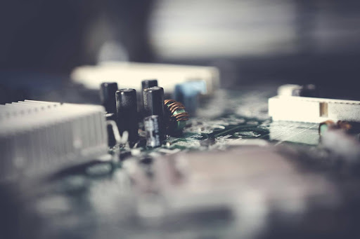 Close-up macro view of a computer circuit board with electronic components and blurred background.